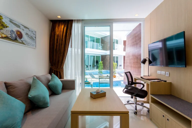 Pool access hotel room in Phuket with a private terrace and outdoor seating area