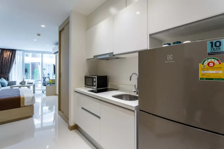 Superior Room with Pool Access at The Beachfront Hotel Phuket featuring a kitchenette and modern amenities